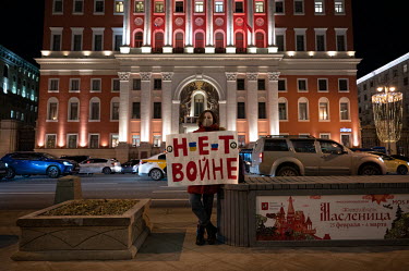 A woman takes part in a 'single picket' protest in the centre of Moscow holding a sign that reads: 'No War'.