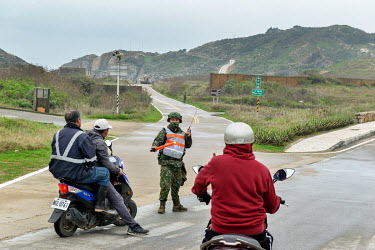 Residents of tiny Dongju, a militarised islet (part of the Matsu archipelago belonging to ROC and lying just off the coast of Fujian Province, China) are halted by an ROC soldier during manoevers at t...