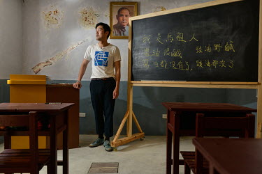 Huang Kai-yang of the Matsu Youth Development Association, a group committed to preserving the islands' historical buildings and culture, stands in a classroom that recreates the atmosphere of a 1960s...