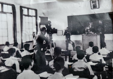 A reproduction of a photograph, collected by the Matsu Youth Development Association, showing US military advisors stationed on the island taking part in a Zhuluo village school lesson in the 1960s at...