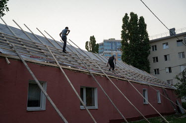 Municipal services are repairing the roof of a building damaged by the Tochka-U rocket explosion which the Russian authorities claim was fired from Ukraine.