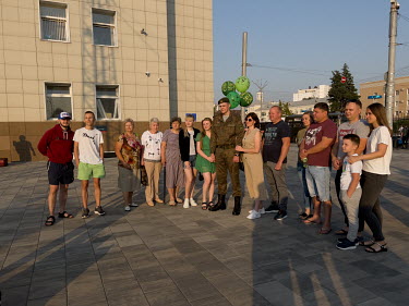 A soldier is met by relatives and friends at Belgorod train station.