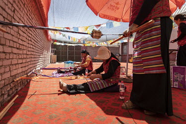Tibetan women weave fabric in a showcase Tibetan village in Golmud. Golmud, the third largest city on the Tibetan plateau, is developing as a key Chinese military staging point for nearby the autonomo...