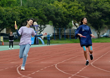 Competitors cross the line at the end of a High School relay race on Nangan, the main island in the Matsu archipelago, a frontline island group belonging to Taiwan that lies just a few miles off the m...