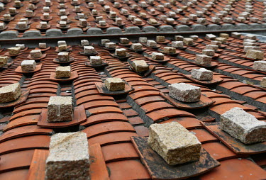 Bricks used to keep roof tiles from flying off in the strong winds that afflict the Matsu Islands, and particulary the older housing in villages like Qinbi. Qinbi is a cluster of traditional Fujianese...