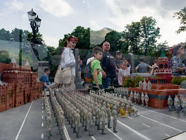 People look at a model as they take part in Russia Day (Unity Day) events and reenactments on June 12 in Moscow.