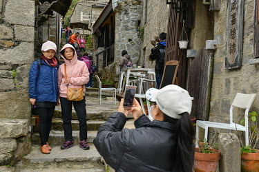 Domestic tourists from mainland Taiwan flocking to the quaint alleyways and staircases of Qinbi Village. Qinbi is a cluster of traditional Fujianese-style stone houses, home to fishermen and smugglers...