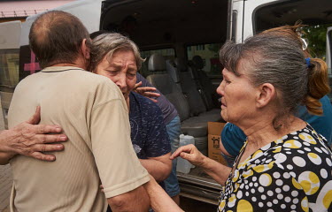 Women cry when saying goodbye to their friends during their evacuation. They have been living together in a cellar for months during heavy shelling by Russian forces and now they decided to leave for...
