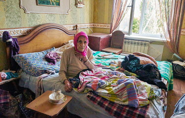Shura (Alexandra) says doesn't want to go anywhere despite the constant bombardment. She does not walk, and she is 80 years old. Her daughter Olya takes care of her, although her mother is grumpy.