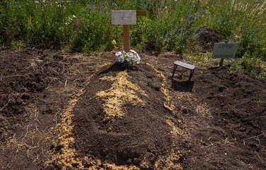 The temporary shallow grave of fifty-three-year-old Romanicheva Svetlana Vladimirovna which was dug by her husband until she could be properly buried. Svetlana died during shelling on 18 June 2022. He...