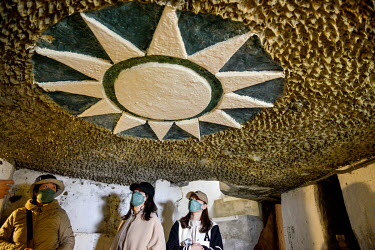 Tourists from the Taiwanese mainland visit a former gun position emblazoned with the Kuomingtang (Nationalist party) sun symbol in an underground complex at Stronghold No.77, one of a string of Cold W...