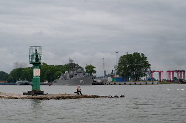 A man fishing near the Baltic Naval Base in Baltiysk, the largest base of the Russian Naval Fleet on the Baltic Sea.