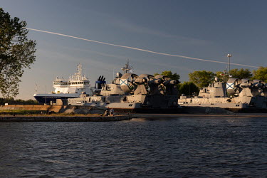 Men fishing near a mooring point for giant military landing hovercraft at the Baltic Naval Base in Baltiysk, the largest base of the Russian Naval Fleet on the Baltic Sea.