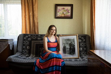 Maria Becker, an ethnic German from the Volga region, with an old family portrait. Maria's relatives were deported from the Volga region to Siberia. Her parents moved from Altai to the Kaliningrad reg...