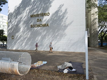 A homeless man sleeps next to the Ministry of Economy, at the Esplanada dos Ministerios.