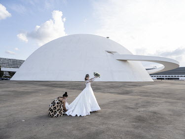 A bride gets ready for a photo shoot at the National Museum of the Republic, designed by Oscar Niemeyer.