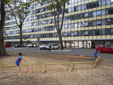 A girl playing in a park in the southern residential wing of a 'superquadra'. Each wing is divided up into 'superquadras', consisting of 20 apartment buildings and a main road which features small bus...