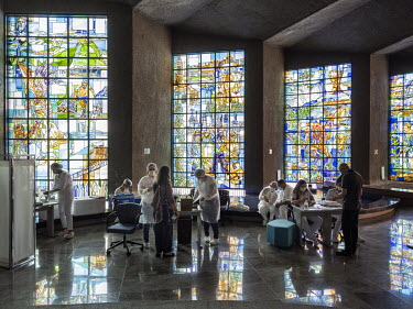 A COVID-19 vaccination centre at Centro Cultural da Caixa, one of the main art and culture centres in Brasilia. Each of the 24 stained glass windows, by Joao Diedman, represent a Brazilian state, thei...