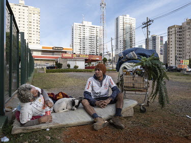 Homeless men in the Aguas Claras, an upscale district of Brasilia, characterised by gated high-rise residential buildings.