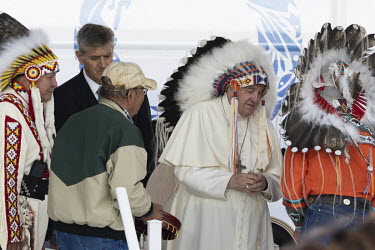 Pope Francis wears a traditional headdress, a gift from Indigenous Chief Wilton 'Willie' Littlechild, during a powwow with Indigenous leaders.Pope Francis toured Canada for a week, including stops in...