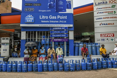 People wait in a line for cooking gas at a petrol station in Colombo amid the economic crisis.
