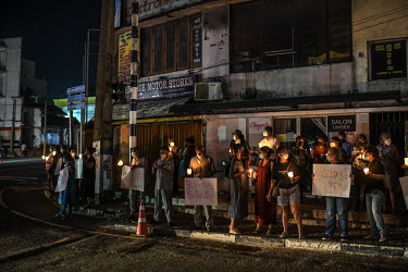 Residents of suburb of Colombo city protest on the street outside their home during a power cut.
