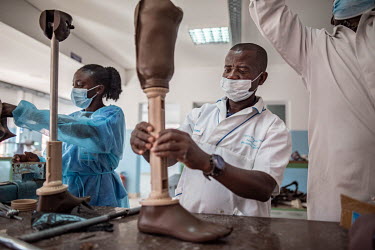 Technicians assemble prosthetic legs at the Princess Diana Orthopaedic Centre. 70 percent of the clinic's patients are landmine victims. Twenty years after the end of its civil war, Angola remains one...