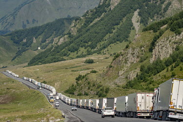 Trucks lined up along the Georgian Military Highway 25km south of the Kazbegi border crossing into Russia. Since Georgia's brief 2008 war with Russia in South Ossetia the GMH is the only route across...