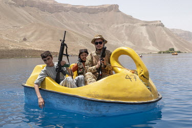 Taliban fighters and tourists spending a Friday in paddle boats on one of the Band-e Amir lakes.