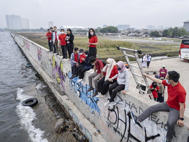 Employees of the the Ministry of National Development Planning Bappenas on a field trip looking at the sea from the sea wall in Muara Baru, northern Jakarta, constructed to protect the city from flood...