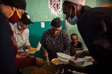 Auntie Sienna, a long term resident of Cissie Gool House, distributes food that had been donated to the occupants as a gift during the month of Ramadan. The building, which was once a government hospi...