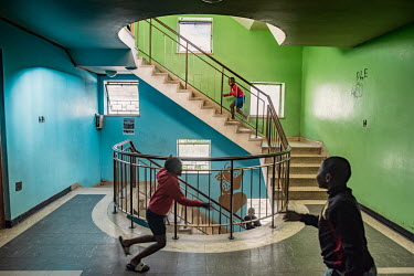 Boys play in a stairwell in Cissie Gool House, an abandoned hospital now home to over 1,000 people. By painting, decorating and maintaining the building, its new residents have managed to turn it into...
