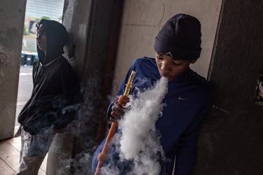Friends Ethan (r) and Justin (l) smoke a hookah pipe in what was once the morgue at the Helen Bowden nursing home. The building is now being occupied by a community of several hundred activists and ev...