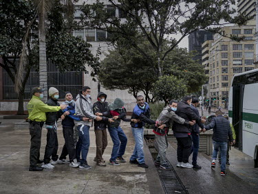 A group of 17 men and women arrested in an anti-drug raid are presented to the public at a police conference in central Bogota.The group are accused of so-called 'micro-traffico', drug smuggling and s...