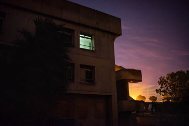 A light shines in a window of Ahmed Kathrada House, a former nursing home in inner-city Cape Town that is now home to a community of several hundred families. The building lacks electricity or running...