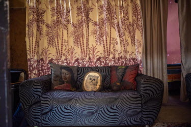 A sofa in the home of 52 year old Elizabeth Daniels and her family in Cissie Gool House, a derelict government-owned hospital in the Woodstock neighbourhood of Cape Town which is now being occupied by...