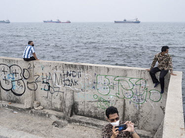 People looking at the sea from the sea wall in Muara Baru, northern Jakarta, constructed to protect the city from flooding.Jakarta, situated in a delta of 13 rivers with 40 percent of land below sea l...