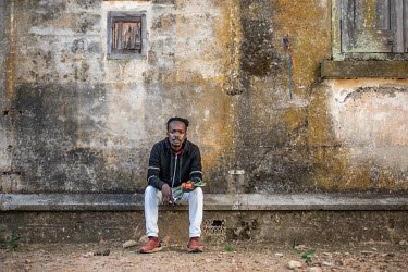 Community leader Unathi Dyanthi, sits outside an abandoned armoury building on an old military base in the Tamboerskloof neighbourhood dating back to 1893. This building, and others on the base, are n...