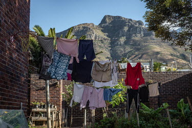 Laundry hangs on a line against a backdrop of Table Mountain in the back garden of Cissie Gool House, an abandoned hospital now home to over 1,000 occupiers.Since 2017, the Reclaim the City movement h...