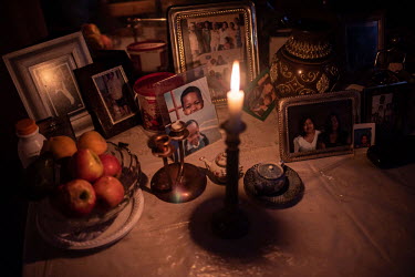 Photos and ornaments lie on a table in 53-year-old Linda Ewy's room in Ahmed Kathrada House, a former nursing home in inner city Cape Town that is now occupied by several hunderd families. The buildin...