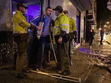 A known drug dealer is aggressively questioned and searched by the police during a patrol in Santa Fe, one of Bogota's deprived areas known for drug consumption and prostitution.
