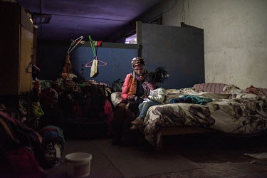 Lillian Mvolontshi and her granddaughter, Phawu watches a video on a phone screen in the abandoned military warehouse where their family now live in central Cape Town. While living in the township of...