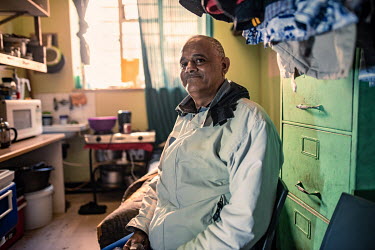 Bevil Lucas, a community leader at Cissie Gool House, in his room, a former doctor's office that he once visited as a patient. Cissie Gool House is an abandoned hospital that has become home to a thri...