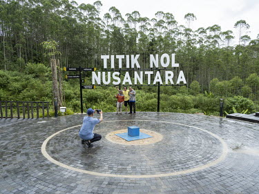 Visitors take pictures at Titik Nol, or Ground Zero, where a blue marker, in the middle of a eucalyptus plantation, indicates the spot where the centre of the new Indonesian capital, Nusantara, will b...