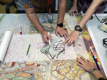 Architect Sofian Sibarani (left), head of urban design studio Urban Plus, and two of his employees drawing a quick sketch in their offices. Urban Plus won the design competition for the new Indonesian...
