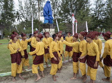 Young men, wearing traditional attire, prepare for the arrival of 40 West Sulawesi-style sailing boats during the annual Sandeq Race Festival. Manggar is a subdistrict of Balikpapan and home to a fish...