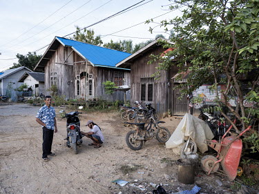 A man repairing his scooter in Sepaku, a village in the site where the new Indonesian capital Nusantara will be built.In 2019, President Widodo announced the plan to move the Indonesian capital from J...
