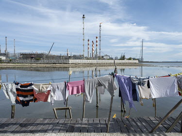 Washing dries on a jetty in the fishing community of Kampung Baru, beside an oil refinery owned by state-owned oil company Pertamina which has been accused of polluting Balikpapan Bay. Balikpapan is o...