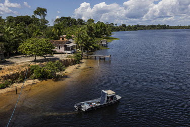 A small boat transports photovoltaic solar panels to the house of a riverside family where they will be installed, in the rural area of Melgaco, in the Marajo Island region. The riverside dwellers of...