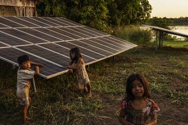 Indigenous children play around the set of solar panels that supplies the Diauarum Pole, in the Xingu Indigenous Territory. Thanks to the energy provided by solar panels it is possible to have interne...
